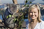 Pretty young woman with feeding koala at Taronga